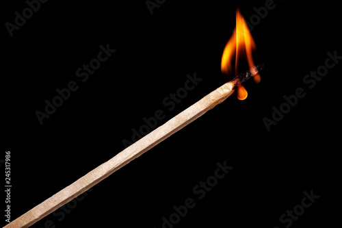 matchstick burning against black