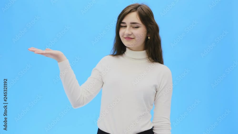 Beautiful young woman with clean, perfect skin. Portrait of beauty model with natural make-up and lifts one hand up. Beautiful young woman with clean, perfect skin. Portrait of beauty model with natural make-up and lifts one hand up.