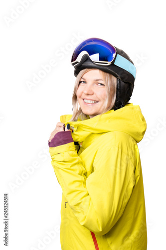 Portrait of a young woman dressed in yellow snowboard jacket, black helmet and glasses