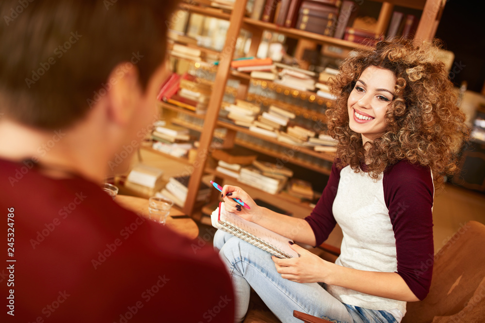 Curly female learn in library