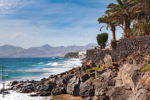 Wavy sea in Puerto del Carmen beach in Lanzarote, Canary islands, Spain, selective focus