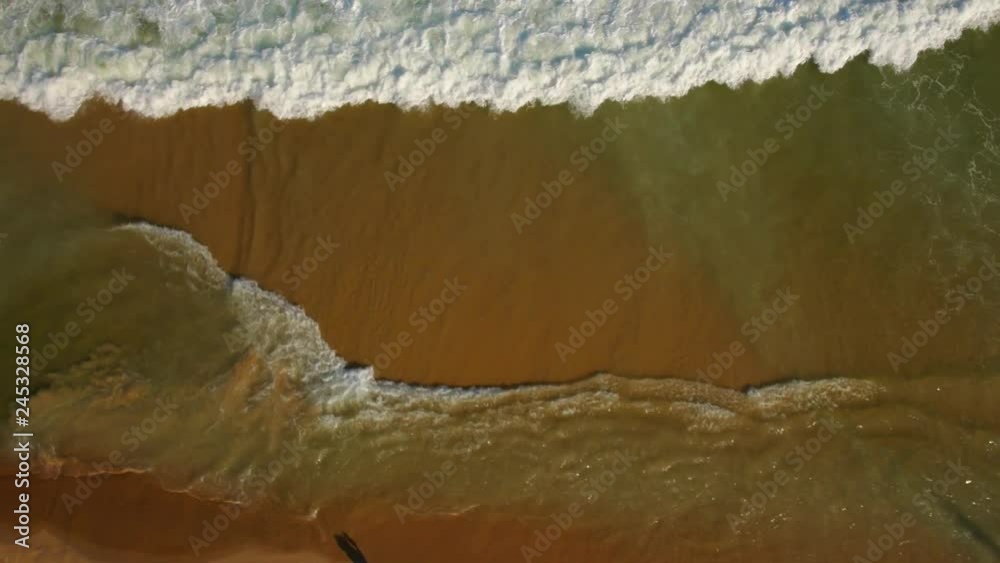 Aerial overhead of waves intersecting on sandy beach Aerial overhead of waves intersecting on sandy beach