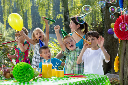 Children enjoying the garden birthday party of their friend