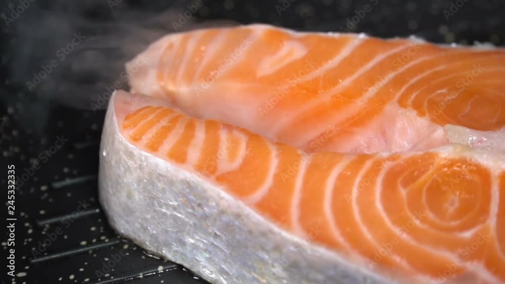 Salmon steak fried in a pan. Slow motion Salmon steak fried in a pan. Slow motion