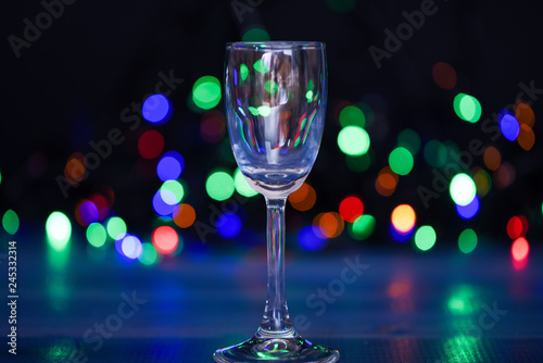 Easy recipes for winter alcoholic cocktail drinks. Cocktail glass on defocused garland colorful lights. What to drink on christmas party. Alcohol cocktail for winter party. Cocktail ideas concept