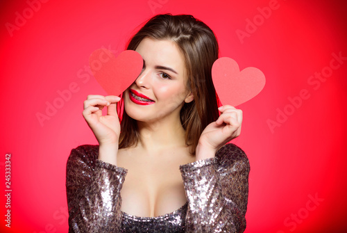 How to kiss with braces. Woman makeup red lips hold heart symbol love. Valentines day concept. Braces and beauty. Dating when you have adult braces. Girl pretty wearing orthodontic braces and smiling