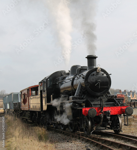 A Vintage Steam Engine Pulling a Goods Freight Train.
