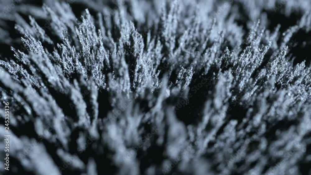 Iron powder under the influence of a magnetic field. Abstract background