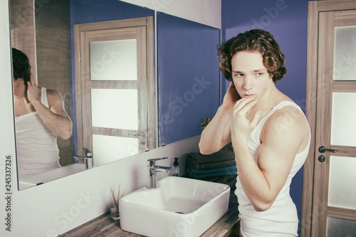 Morning and hygiene. Attractive guy in the bathroom. 