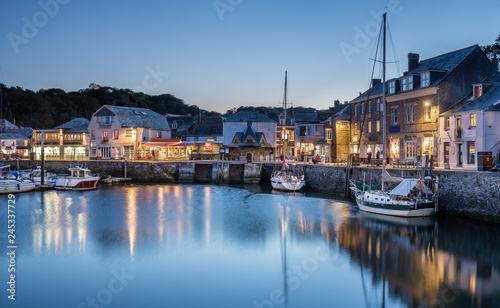 Blue Hour over Padstow Harbour, with reflections of boats and lights photo