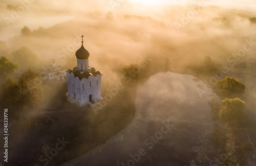 Church of the Intercession of the Holy Virgin on the Nerl River in autumn fog, Russia. Air view