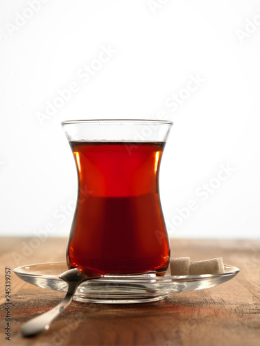 Hot Turkish tea with spoon and two sugars.