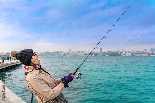 Beautiful woman catches fish in Istanbul,Turkey