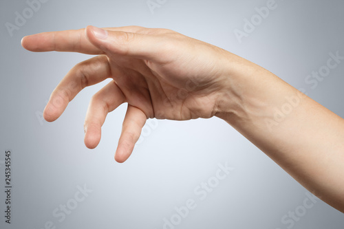 Relaxed hand on grey background photo