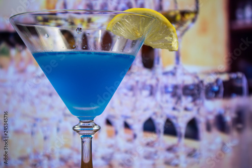 Blue Kamikaze cocktail in martini glass decoreted slice of lemon