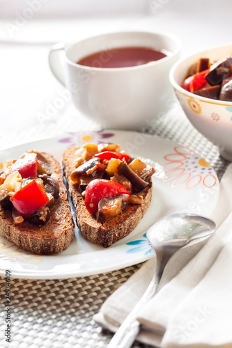 Vegetable stew with eggplant  red pepper and tomatoes on toasted rye bread