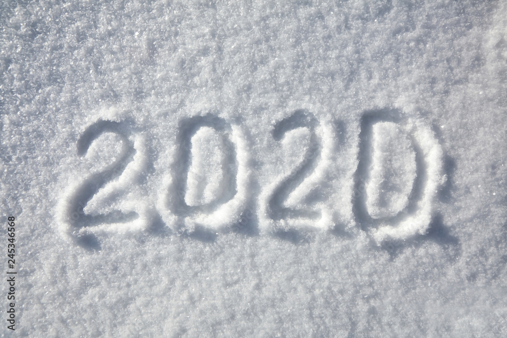 winter inscription 2020 New Year background, text on snow surface winter inscription 2020 New Year background, text on snow surface