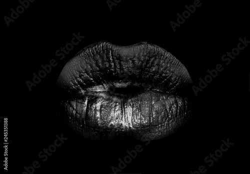 Black lips. Mouth icon. Woman lips isolated on black background. Luxury dark cosmetics.