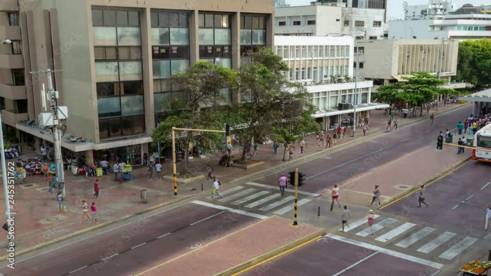 time-lapse of crowds and buses driving down dedicated bus lanes in the old part of Cartagena in Colombia.