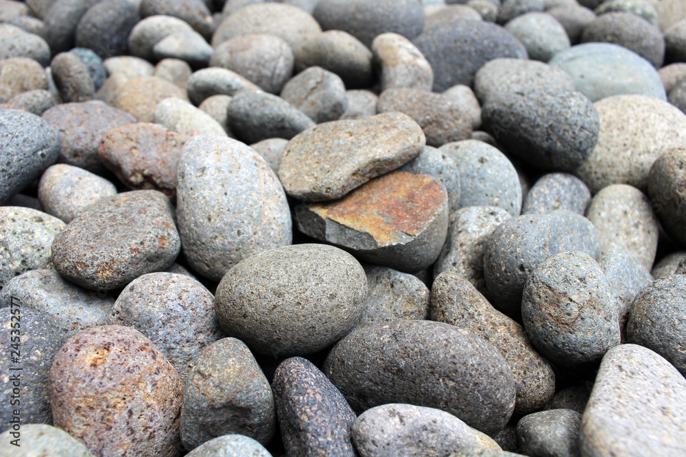 A broken pebble among stones in the garden. A broken pebble among stones in the garden.