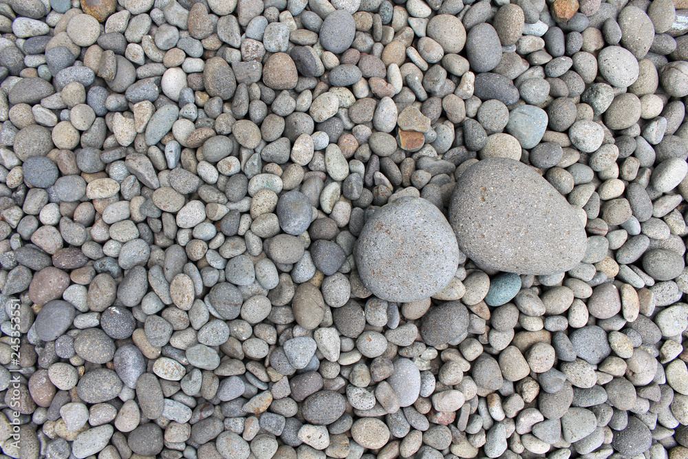 Big stones among smaller pebbles, in the garden. Big stones among smaller pebbles, in the garden.