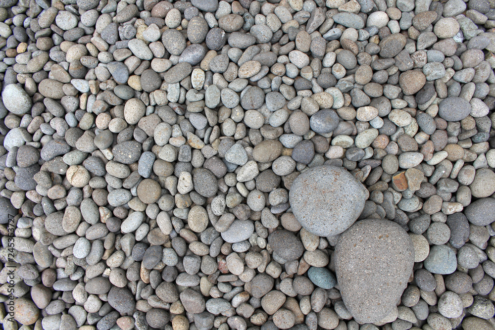 Big stones among smaller pebbles, in the garden. Big stones among smaller pebbles, in the garden.