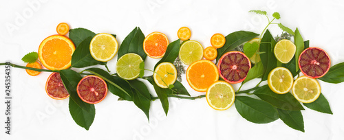 Fototapeta Naklejka Na Ścianę i Meble -  many different fresh citrus fruits on white crumpled paper background