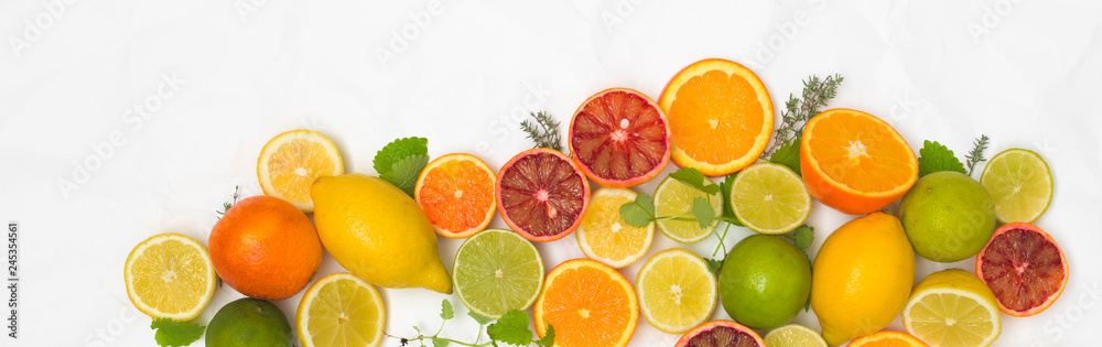 many different fresh citrus fruits on white crumpled paper background many different fresh citrus fruits on white crumpled paper background