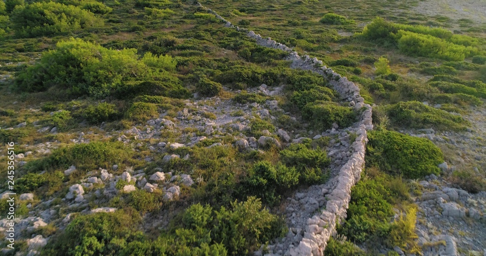 Village ruins, C4k aerial, tilt down, drone shot, over a old wall ruin, near Razanj town, on the croatian coast, on a sunny, summer day, in Croatia Village ruins, C4k aerial, tilt down, drone shot, over a old wall ruin, near Razanj town, on the croatian coast, on a sunny, summer day, in Croatia