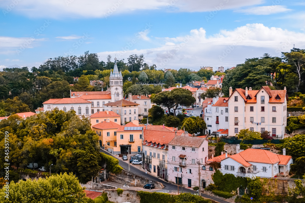 Group of buildings in a village surrounded by forest trees in the old town near the Palace of Sintra. Lisbon, Portugal.