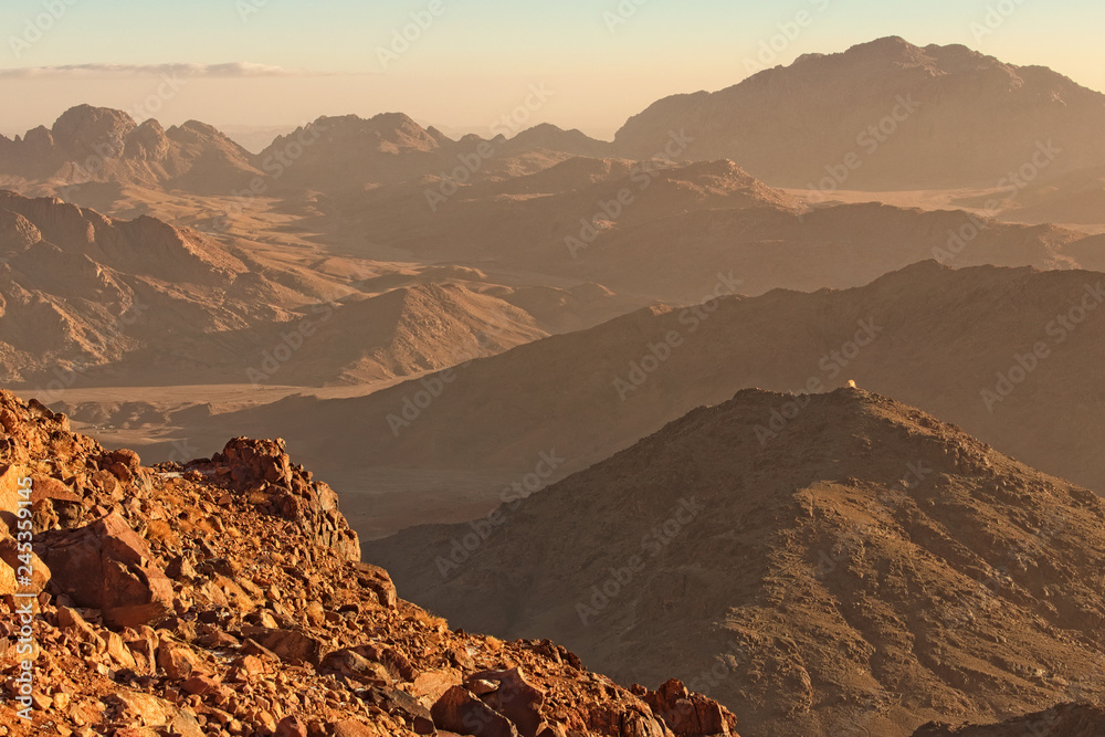Picturesque landscape of mountains peaks during sunrise. View from Mount Sinai (Mount Horeb, Gabal Musa). Sinai Peninsula of Egypt. Famous touristic place and travel destination in Egypt