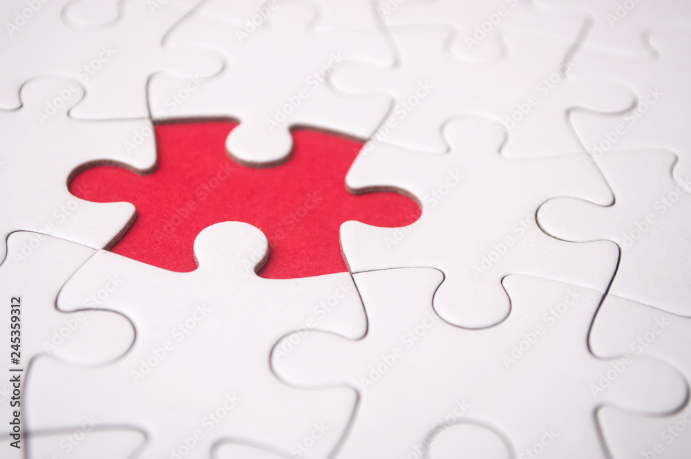 the last piece of jigsaw puzzle missing on red background to complete the mission the last piece of jigsaw puzzle missing on red background to complete the mission