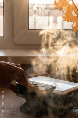 the woman does wafers in kitchen, vapours