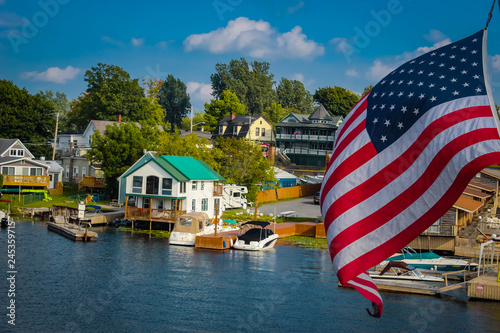 The lake town, boats and the american flag in focus