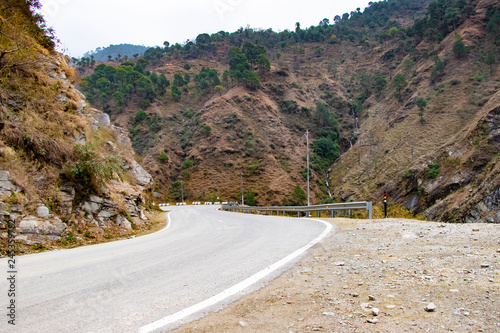 Scenic road through the valley of banikhet dalhousie himachal pradesh covered with mountain and trees. Driving uphill scenic road travel concept photo