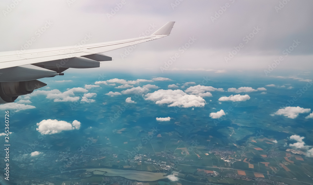 aerial view. wing of an airplane flying above the clouds