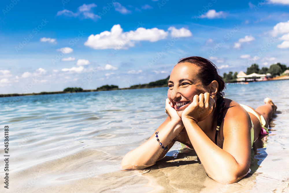 Happy woman enjoying in summer day at sea. Happy woman enjoying in summer day at sea.