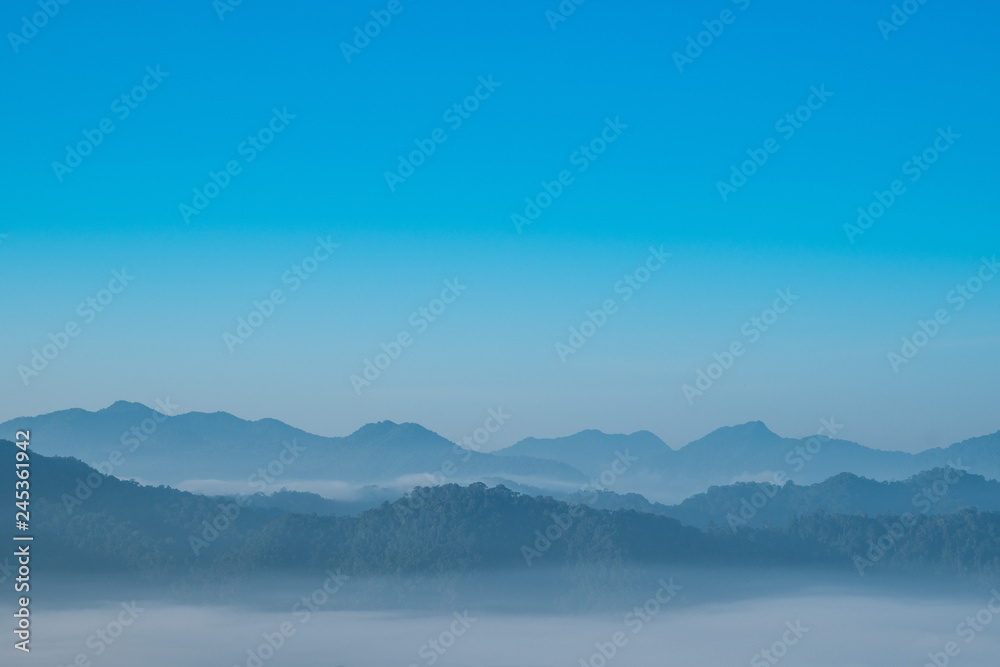 Foggy and mountain on edge range with copy-space on sky