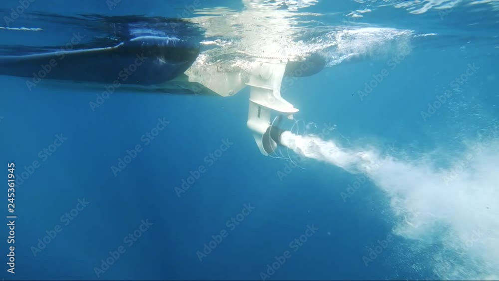 slowmotion shot of boat propeller starts with nice air bubbles turning around the propeller
