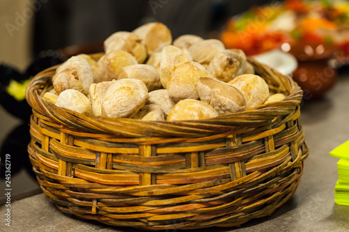 Wooden basket with white buns