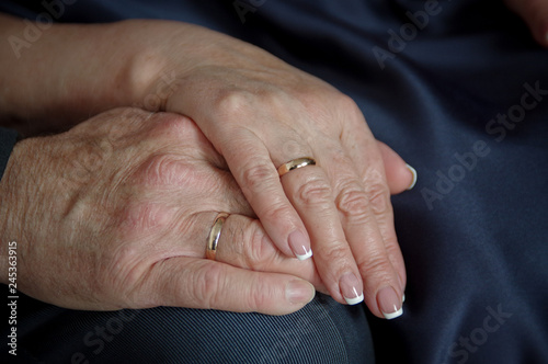 Hands of the bride and groom with gold wedding rings. Wedding concept.