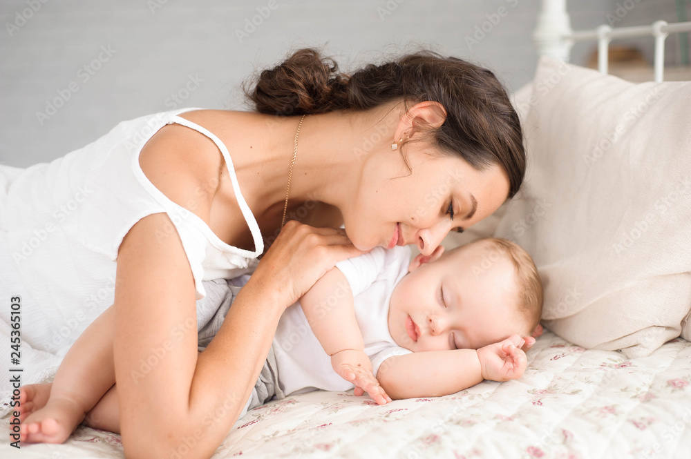 Sweet baby boy sleeping in bed with his mother Sweet baby boy sleeping in bed with his mother
