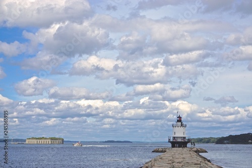 South Portland, Maine, USA: Spring Point Ledge Light (1897) and Fort Gorges (1864) under dramatic cloud formations in Casco Bay, Maine. photo