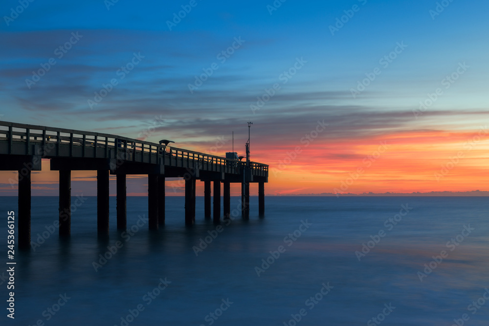 Sunrise over the Atlantic Ocean at the St. Augustine Beach Pier in St. Augustine, Florida Sunrise over the Atlantic Ocean at the St. Augustine Beach Pier in St. Augustine, Florida