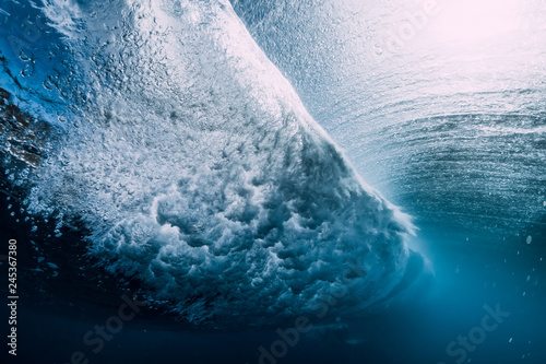 Fototapeta Naklejka Na Ścianę i Meble -  Barrel wave underwater with air bubbles and sun light. Blue crystal ocean in underwater