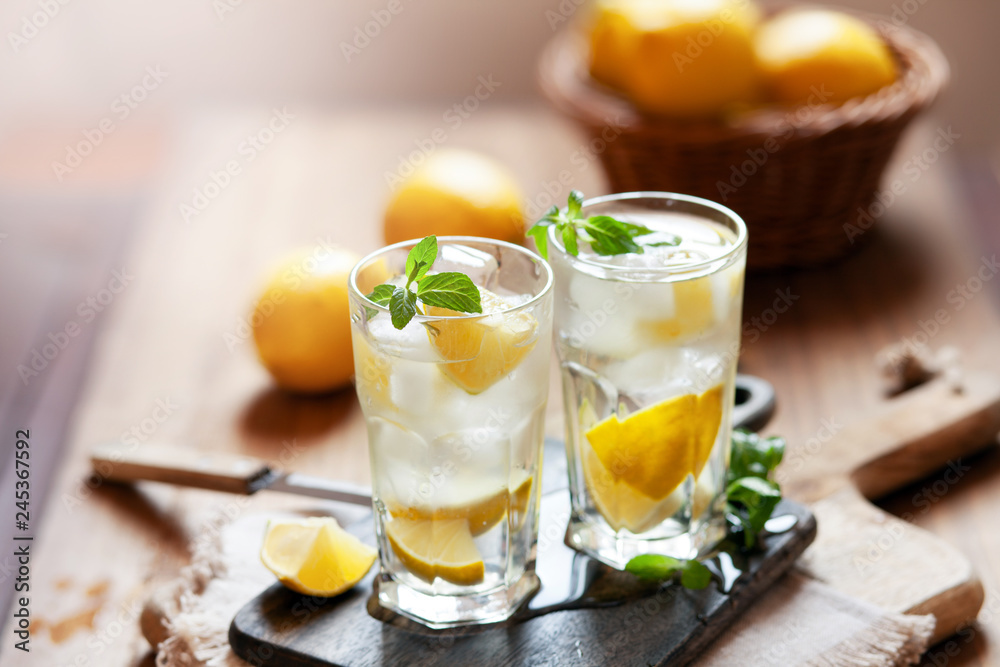 Refreshing summer drink with lemon, mint and ice copy space Refreshing summer drink with lemon, mint and ice copy space