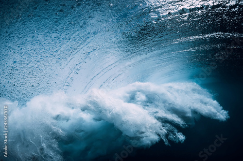 Wave underwater with air bubbles. Ocean in underwater