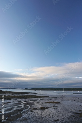 Saint Andrews, New Brunswick, Canada: View of the Bay of Fundy at low tide in the early morning with dramatic cloud formations overhead.