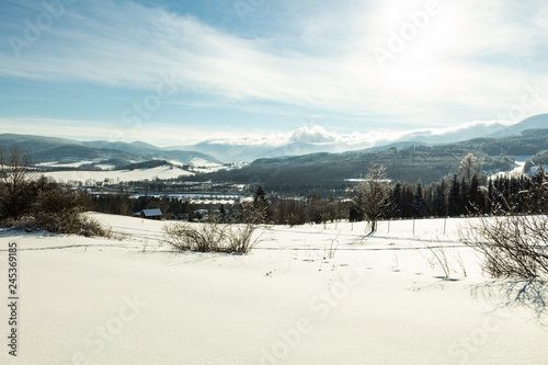 Clear sunny sky with a beautiful landscape on snow covered trees in a evanescent Christmas morning in the mountains.