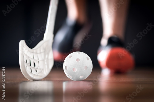 Floorball player running with ball and stick. Floor hockey concept. photo